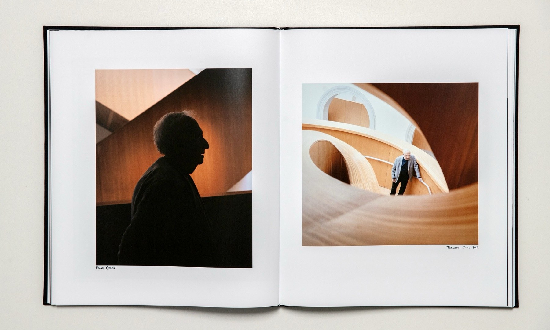 Open spread: a silhouetted figure beside curved wooden architecture